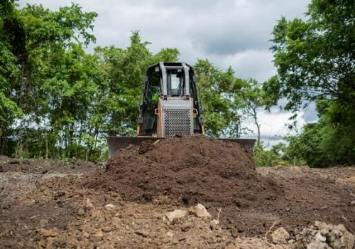Earth mover pushing dirt as Brex company sets new standards in construction.